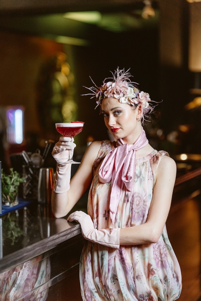 a woman holding a drink